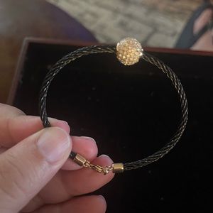 Black cable bracelet with gold and crystal accents